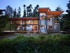Modern home with Exterior, House Building Type, Shed RoofLine, Metal Roof Material, and Metal Siding Material. Exterior view of house on the east side, toward the Hood Canal Photo of Port Ludlow House