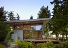 Modern home with Exterior, Metal Roof Material, House Building Type, Shed RoofLine, Metal Siding Material, and Glass Siding Material. South side of house, with 6-ft roof overhangs and large sliding glass panels Photo 2 of Port Ludlow House