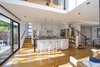 Open kitchen with bar, supported by reclaimed I-beam Photo 19 of Hillview House modern home