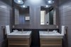 Master bath wall-mounted sinks, tongue-and-groove siding and flush skylight Photo 12 of Hillview House modern home