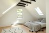 Modern home with Bedroom, Bed, Ceiling Lighting, and Light Hardwood Floor. upstairs bedroom with added skylights Photo 9 of Country House With a Modern Edge