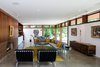 Modern home with Living Room. The mostly transparent street elevation gives a glimpse into the home, while the fireplace feature wall provides privacy to the rear spaces. Photo 4 of Pleasant Street Residence