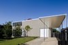 Modern home with Exterior, Flat RoofLine, House Building Type, Metal Roof Material, and Brick Siding Material. Design provides a delicate layer of privacy, capturing the coastal breezes from all rooms and successfully bringing the outside in. Photo 2 of The Naranga Avenue House