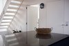 Modern home with Kitchen and Metal Counter. Stainless steel kitchen worktops and new metal stairs leading to roof terrace Photo 4 of The Science Lab