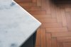 Modern home with Bath Room, Marble Counter, Medium Hardwood Floor, and Pedestal Sink. Carrara marble bathroom worktops Photo 2 of The Science Lab