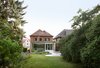 Modern home with Outdoor, Gardens, Grass, Shrubs, Back Yard, Garden, Small Patio, Porch, Deck, Flowers, Trees, Hardscapes, and Concrete Patio, Porch, Deck. New addition from outdoor garden Photo 9 of Leuven Residential Addition