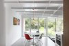Modern home with Dining Room, Table, Chair, Ceiling Lighting, Storage, and Concrete Floor. Interior view toward breakfast area Photo 6 of Leuven Residential Addition