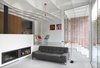 Modern home with Living Room, Wood Burning Fireplace, Lamps, Ceiling Lighting, Chair, Sofa, Concrete Floor, and Ribbon Fireplace. Interior view East Photo 5 of Leuven Residential Addition