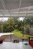 Modern home with Living Room, Sofa, Ceiling Lighting, and Concrete Floor. View from addition interior to outdoor garden Photo 2 of Leuven Residential Addition