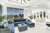 The white interiors and glass offer a clean view to the outside. Photo 3 of A Zen Marco Island Retreat modern home