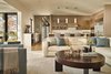 Modern home with Kitchen, Light Hardwood Floor, Refrigerator, Range Hood, Wood Cabinet, Engineered Quartz Counter, Pendant Lighting, Recessed Lighting, Wall Oven, and Cooktops. A large leather sectional grounds the family room Photo 9 of Union Bay Residence