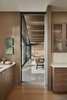 Modern home with Kitchen, Wood Cabinet, Light Hardwood Floor, Engineered Quartz Counter, and Undermount Sink. White oak cabinets are used within the kitchen Photo 10 of Union Bay Residence