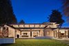 An evening view of the home from the lake Photo 16 of Union Bay Residence modern home
