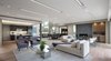 Modern home with Living Room, Sofa, Pendant Lighting, Coffee Tables, Chair, Gas Burning Fireplace, Accent Lighting, Ceiling Lighting, Recessed Lighting, and Light Hardwood Floor. Great Room - Lounge/Kitchen/Dining Photo 12 of Oxford Residence