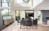 Modern home with Dining Room, Porcelain Tile Floor, Pendant Lighting, Chair, Light Hardwood Floor, Storage, Gas Burning Fireplace, Ceiling Lighting, and Table. Double Height Volume - Dining Photo 13 of Oxford Residence