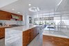 Modern home with Kitchen, Marble Counter, Marble Backsplashe, Concrete Floor, and Wood Cabinet. Fully renovated, modern kitchen with gas range, refrigerated drawers and ice maker for all of the Palm Springs cocktails! Photo 3 of Donald Wexler's Steel House #4 in Palm Springs