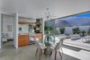 Dining room and wine bar with wall of glass open to backyard firepit and pool patio. Photo 6 of Donald Wexler's Steel House #4 in Palm Springs modern home