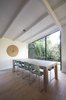 Modern home with Dining Room, Pendant Lighting, Table, Chair, Light Hardwood Floor, and Ceiling Lighting. the dining area with a view of the garden Photo 2 of Grey House