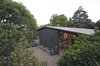 Modern home with Exterior, Mid-Century Building Type, Brick Siding Material, Gable RoofLine, House Building Type, and Shingles Roof Material. northern view of the house Photo 5 of Grey House