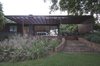 Modern home with Outdoor, Back Yard, Garden, Stone Patio, Porch, Deck, Gardens, Grass, Decking Patio, Porch, Deck, Trees, and Wood Patio, Porch, Deck. a deck and pergola where added to the original late 50's structure Photo 3 of Grey House