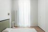 Modern home with Bedroom, Medium Hardwood Floor, Storage, Bed, Wall Lighting, and Ceiling Lighting. Meta Side Table by New Tendency | view from bedroom Photo 7 of A-PLACE by Thisispaper Studio