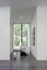 Modern home with Windows, Metal, and Picture Window Type. Looking north from the front door, one looks through a 12'h x 8' w window looking on the stone embedded in the landscape which came from the excavated bedrock when construction the home.
Photo 5 of The Winnwood Residence