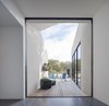 Two large multi-slide doors open up the main living space to the exterior. The opening picture faces east towards the land and water conservation project across the street; it is 12' h x 10' w. Photo 6 of The Winnwood Residence modern home
