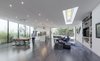 Modern home with Living Room, Ceiling Lighting, Pendant Lighting, Sectional, Bookcase, Dark Hardwood Floor, Ribbon Fireplace, Console Tables, End Tables, Chair, Coffee Tables, and Recessed Lighting. The large living space is surrounded by glass providing copious amounts of natural light. Photo 10 of The Winnwood Residence