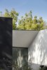 Enlarged view of the knife edge roof detail. By reducing the roof line to a sharp edge, the black and white walls of the home provide contrast to the sky and surrounding vegetation. Photo 16 of The Winnwood Residence modern home