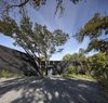 Modern home with Outdoor, Trees, Hardscapes, Shrubs, and Front Yard. Picture of the motor court. Despite its appearance, this photo was not distorted. The numerous trees on the property paint the landscape from all directions creating an interesting tapestry of shadows. Photo 17 of The Winnwood Residence
