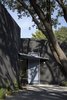 The front door is covered by a wing-like structure. Photo 18 of The Winnwood Residence modern home