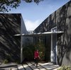 The front door is covered by a wing-like structure. Photo 19 of The Winnwood Residence modern home