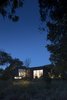 Viewed from the street looking west, the first third of the lot was landscaped to be an extension of the adjacent land and water conservation project and to provide an undisturbed animal habitat. Photo 2 of The Winnwood Residence modern home