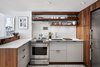 Modern home with Kitchen, Recessed Lighting, Ceramic Tile Backsplashe, Subway Tile Backsplashe, Ceiling Lighting, Range, Refrigerator, Range Hood, Wood Cabinet, Drop In Sink, and Wine Cooler. Refrigerator by Liebherr
Dishwasher by Bosch
Wine Refrigerator by Summit Photo 3 of 4th Ave./Union Square Apartment