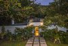 Modern home with Outdoor, Stone Fences, Wall, Shrubs, Front Yard, Concrete Fences, Wall, Raised Planters, Walkways, Landscape Lighting, Trees, and Gardens. Street entrance Photo 2 of Nuuanu Heritage Estate