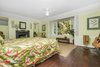Modern home with Bedroom, Bed, Medium Hardwood Floor, and Ceiling Lighting. Master bedroom is classic Hawaiiana with original hardwood floors, original sliding windows, and fireplace Photo 4 of Nuuanu Heritage Estate