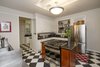 Modern home with Kitchen, Linoleum Floor, Refrigerator, Range, Metal Counter, White Cabinet, and Ceiling Lighting. Owners have kept the retro kitchen black and white tile floor, butler pantry, and swinging door Photo 5 of Nuuanu Heritage Estate
