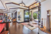 Modern home with Living Room, Ceiling Lighting, Table, Dark Hardwood Floor, and Accent Lighting. Oversized glass front doors and custom stained glass transom make a statement. Photo 3 of Hawaii Architect's Home in Keauhou Estates