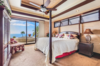 Modern home with Bedroom, Ceiling Lighting, Table Lighting, Dresser, Recessed Lighting, Dark Hardwood Floor, Lamps, Night Stands, Chair, Rug Floor, and Bed. Incredible views from the master suite. Photo 9 of Hawaii Architect's Home in Keauhou Estates