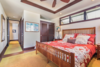 Modern home with Bedroom, Night Stands, Bed, Recessed Lighting, Rug Floor, Dark Hardwood Floor, and Table Lighting. One of two guest suites. Photo 11 of Hawaii Architect's Home in Keauhou Estates