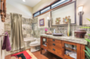 Modern home with Bath Room, Recessed Lighting, Full Shower, Wall Lighting, One Piece Toilet, Granite Counter, Vessel Sink, Stone Tile Wall, Drop In Tub, and Rug Floor. Bath for adjoining guest suite. Photo 12 of Hawaii Architect's Home in Keauhou Estates