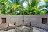 Modern home with Bath Room, Open Shower, and Stone Tile Wall. Artisan stone wall with private shower surrounded by lush garden. Photo 7 of Launiupoko Luxury Estate