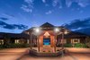 An illuminated entrance as the sun sets. Photo 13 of Launiupoko Luxury Estate modern home