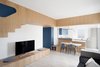 Modern home with Living Room, Concrete Floor, Painted Wood Floor, Wall Lighting, Sofa, Chair, and Table. The whole main room of the house Photo 6 of Into the Woods