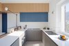 Modern home with Kitchen, Drop In Sink, Wall Oven, Cooktops, Engineered Quartz Counter, Colorful Cabinet, Concrete Floor, and Wall Lighting. View of the kitchen Photo 7 of Into the Woods