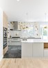 Modern home with Kitchen, Engineered Quartz Counter, Range Hood, Porcelain Tile Floor, Cooktops, Wall Oven, Undermount Sink, Wood Cabinet, Ceiling Lighting, Pendant Lighting, White Cabinet, Light Hardwood Floor, and Ceramic Tile Backsplashe. Kitchen Photo of The Rockcliffe Renovation