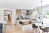 Modern home with Kitchen, White Cabinet, Cooktops, Engineered Quartz Counter, Light Hardwood Floor, Porcelain Tile Floor, Range Hood, Accent Lighting, Pendant Lighting, Microwave, Ceiling Lighting, Ceramic Tile Backsplashe, Wall Oven, and Undermount Sink. Kitchen Photo 2 of The Rockcliffe Renovation