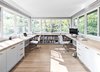 Modern home with Office, Study Room Type, Library Room Type, Desk, Chair, Shelves, Lamps, Light Hardwood Floor, Storage, and Bookcase. Office Photo 10 of The Rockcliffe Renovation
