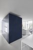Modern home with Kitchen, Painted Wood Floor, Ceiling Lighting, and Wall Oven. A dark blue block is the central pole of the kitchen area. Deposited directly on the floor, its periphery creates a zone of circulation. Photo 5 of The House on Drolet Street