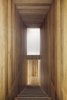 Modern home with Staircase and Wood Tread. The staircase space, darker, marks a pause at the passage of the two bright levels. Photo 16 of The House on Drolet Street